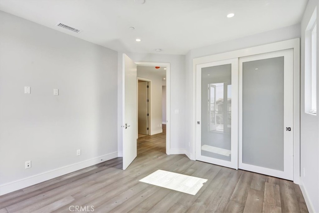 1908 Perry Avenue, Unit B Redondo Beach, CA 90278 - Photo 8 of 20 wooden floor in an empty room with a window