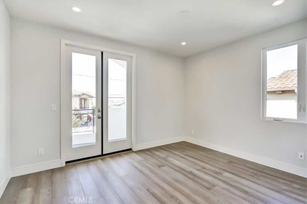 1908 Perry Avenue, Unit B Redondo Beach, CA 90278 - Photo 9 of 20 a view of an empty room with wooden floor and a window