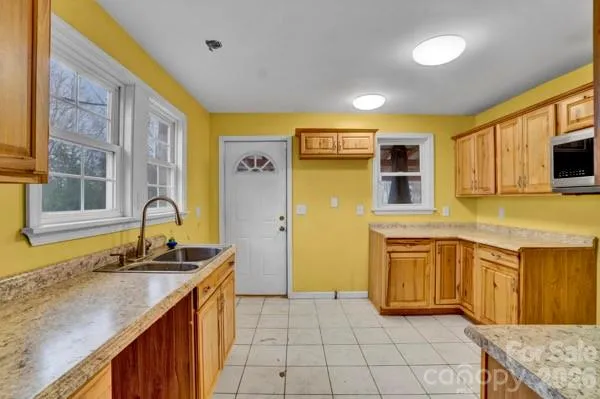 a kitchen with stainless steel appliances granite countertop a sink and a stove