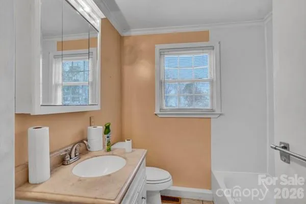 a bathroom with a sink toilet a mirror and shower