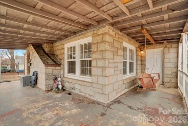 a view of a room with wooden walls and furniture
