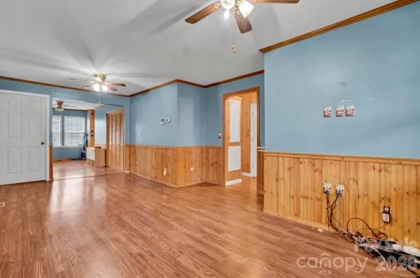 a view of empty room with wooden floor