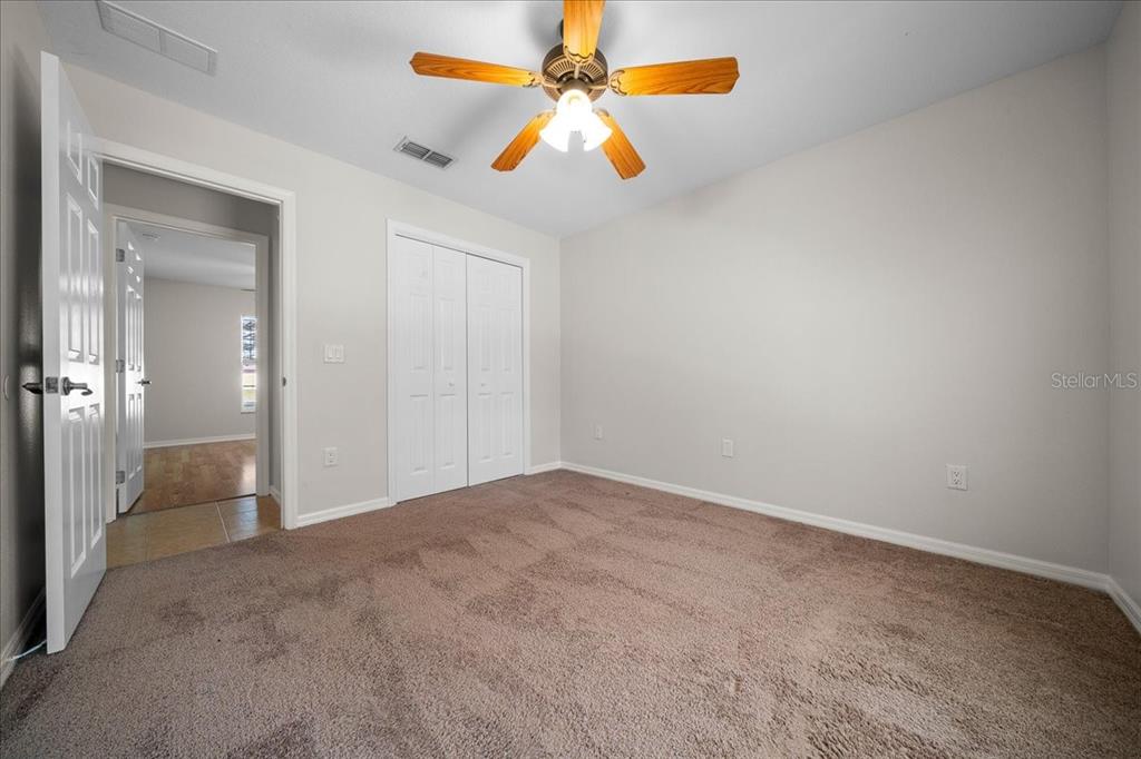 234 Locust Lane Ocala, FL 34472 - Photo 68 of 71 an empty room with closet and a chandelier fan