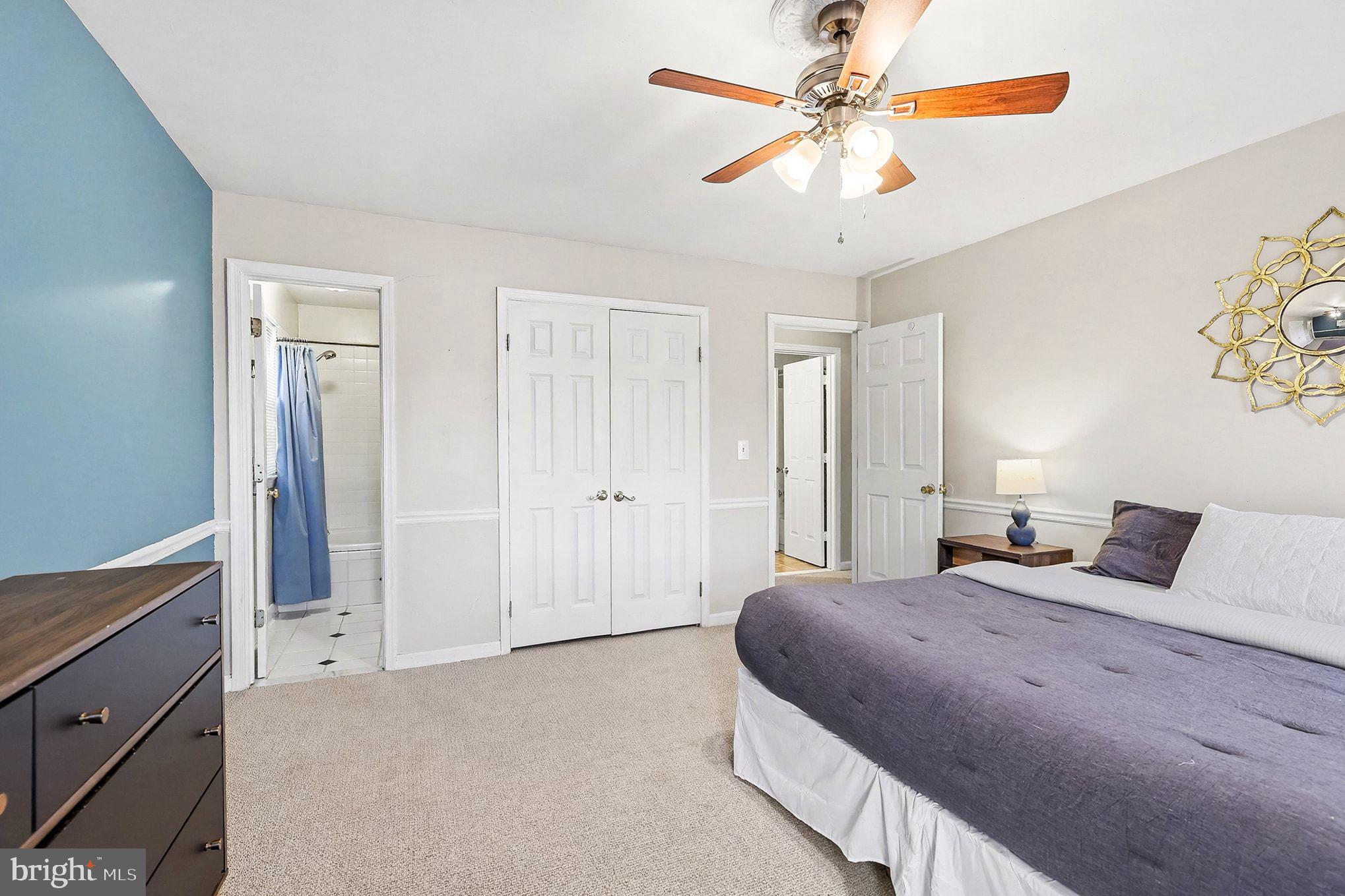 5822 Jackson Road Fredericksburg, VA 22407 - Photo 15 of 26 a bedroom with a large bed and a chandelier