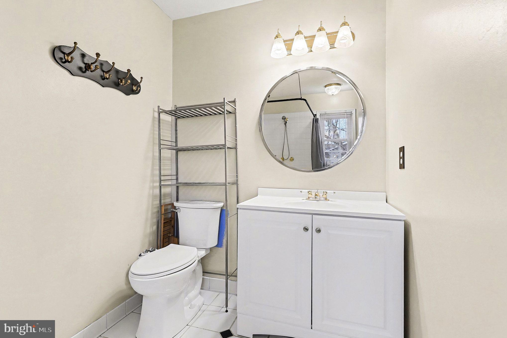 5822 Jackson Road Fredericksburg, VA 22407 - Photo 16 of 26 a bathroom with a sink mirror and toilet