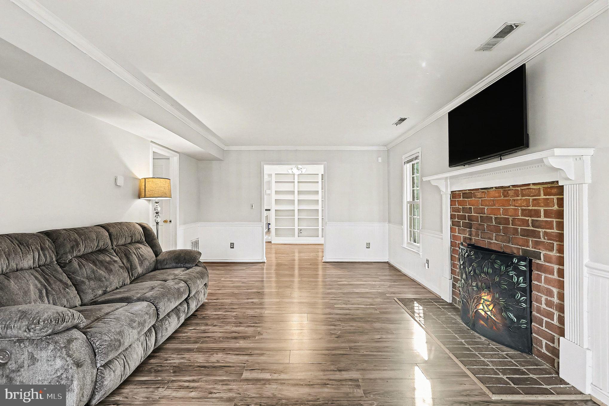 5822 Jackson Road Fredericksburg, VA 22407 - Photo 2 of 26 a living room with furniture and a fireplace