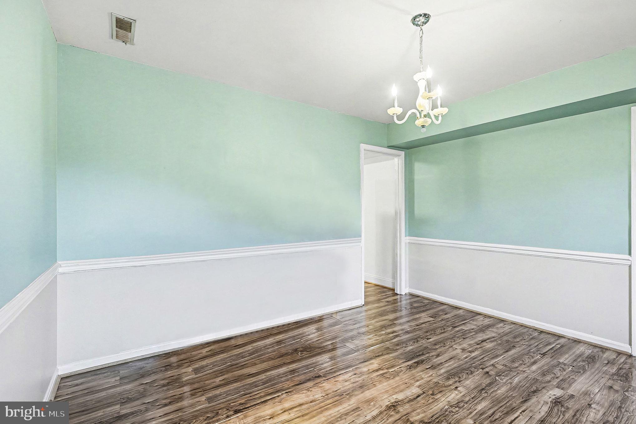 5822 Jackson Road Fredericksburg, VA 22407 - Photo 5 of 26 a view of a spacious bathroom with wooden floor and chandelier