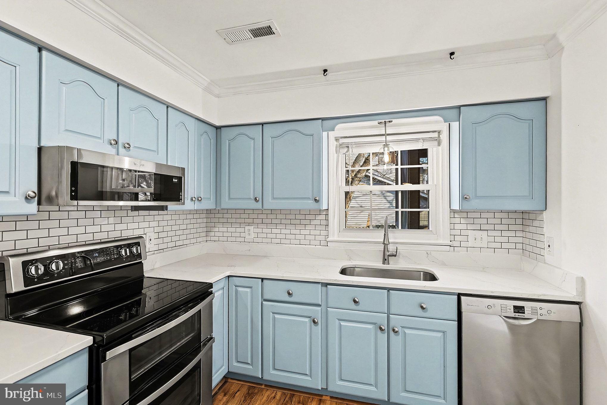 5822 Jackson Road Fredericksburg, VA 22407 - Photo 8 of 26 a kitchen with cabinets appliances a sink and a window