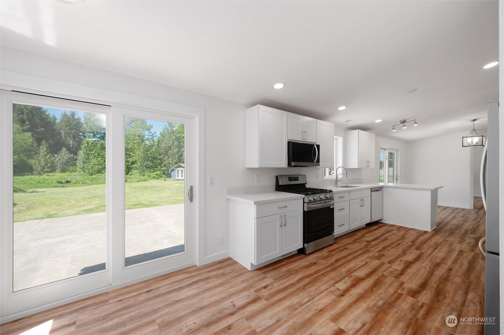 5805 Lawrence Road Everson, WA 98247 - Photo 30 of 35 a kitchen with a sink wooden floor and stainless steel appliances
