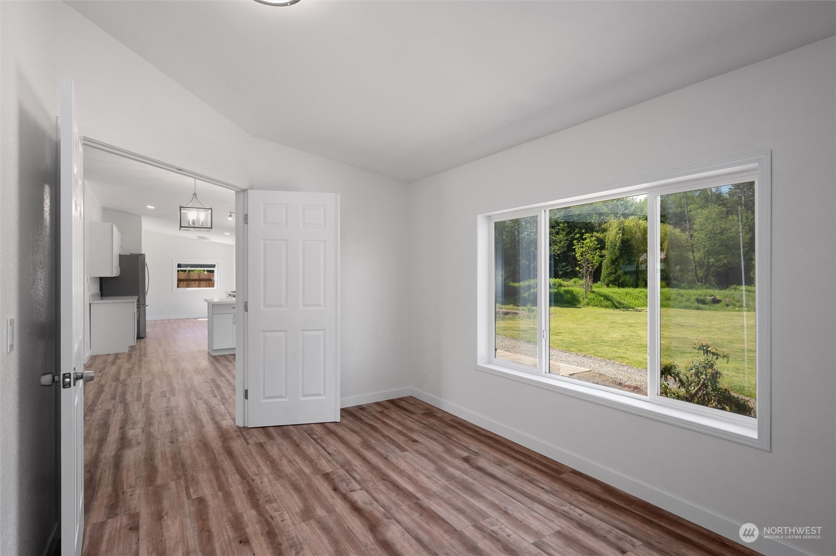 5805 Lawrence Road Everson, WA 98247 - Photo 31 of 35 a view of an empty room with wooden floor and a window