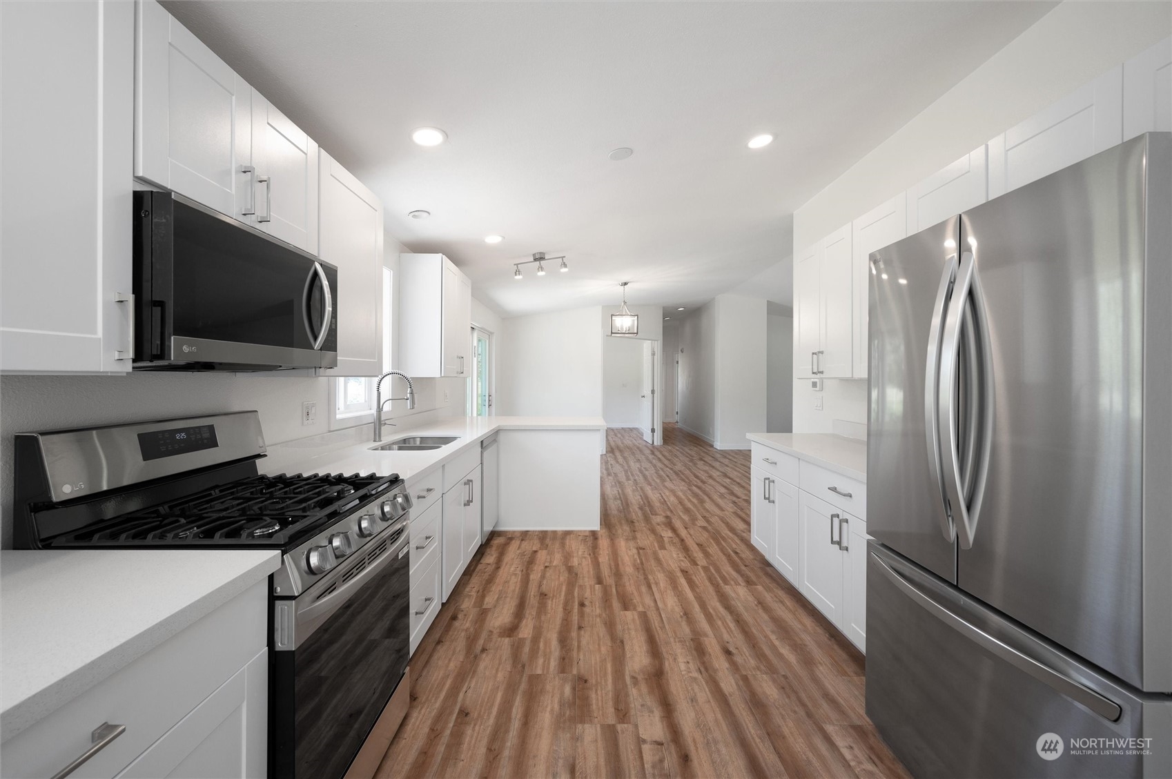 5805 Lawrence Road Everson, WA 98247 - Photo 34 of 35 a kitchen with stainless steel appliances a refrigerator a stove a microwave oven a sink and cabinets