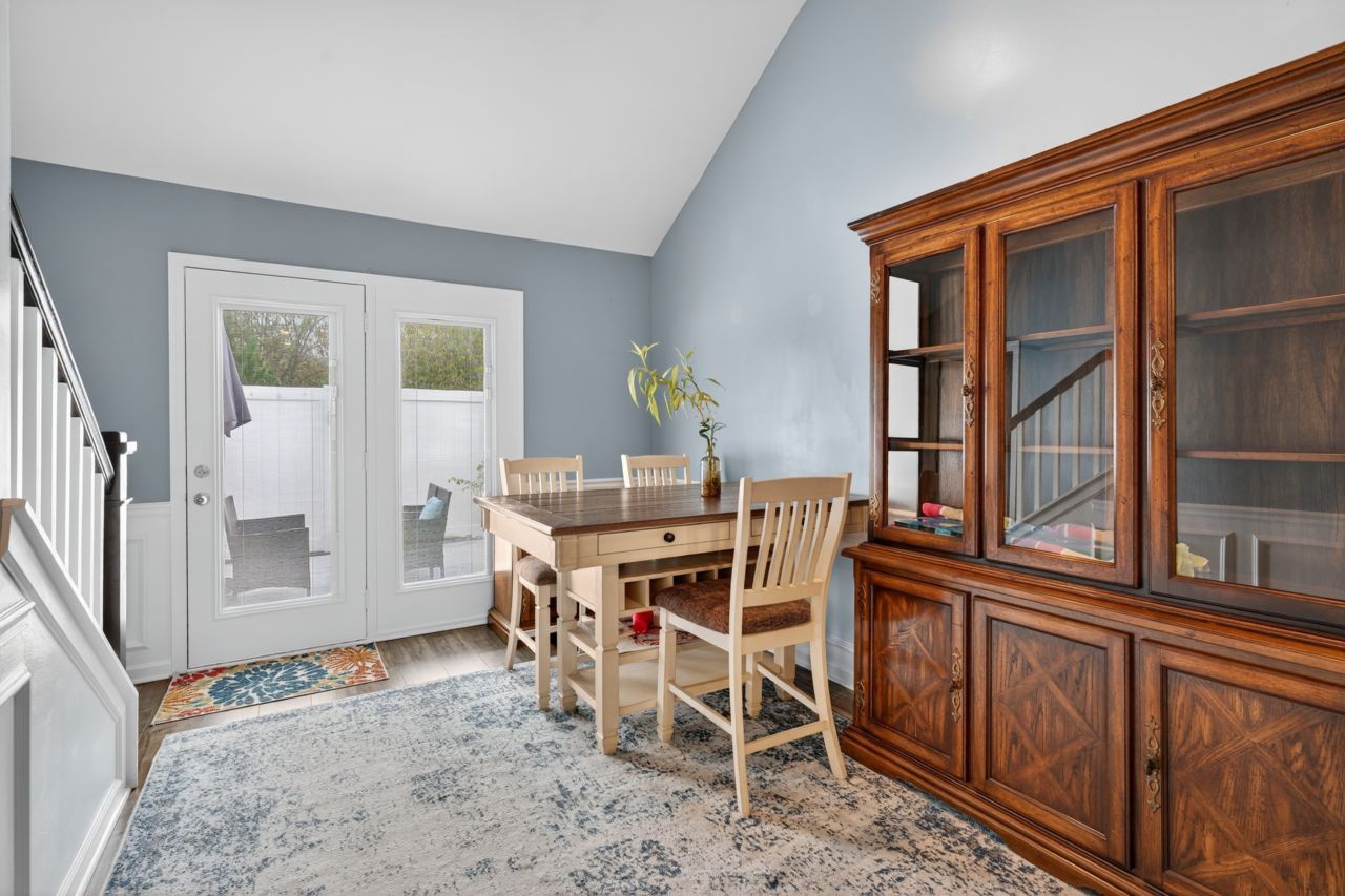 2040 Alysheba Run Murfreesboro, TN 37128 - Photo 7 of 22 a dining room with furniture a rug and wooden floor