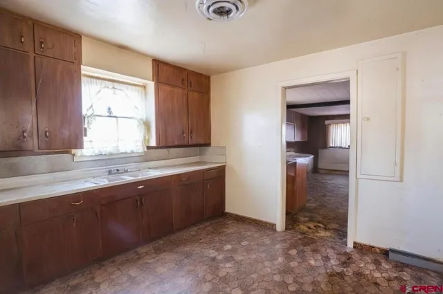a view of stainless steel kitchen with a refrigerator and microwave