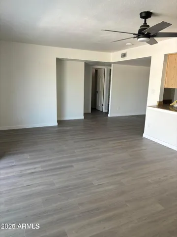 a view of a room with wooden floor