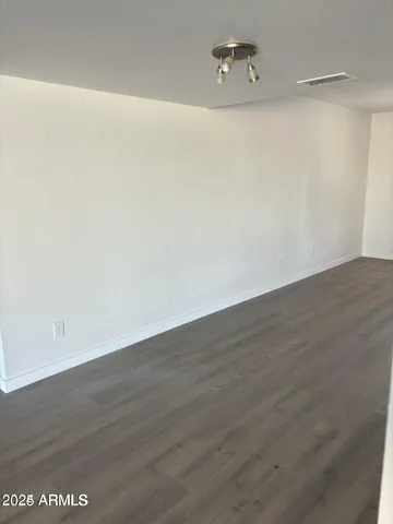a view of a room with wooden floor