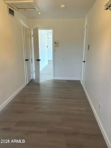 a view of a hallway with wooden floor