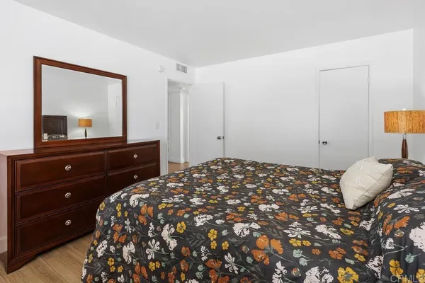 a bedroom with a bed and a dresser