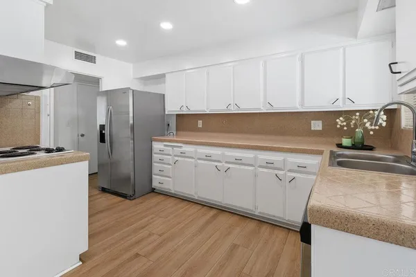 a kitchen with cabinets and stainless steel appliances