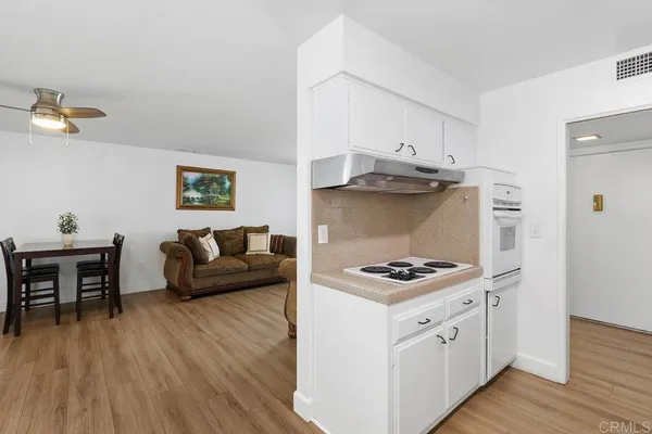 a kitchen with stainless steel appliances a white stove top oven and cabinets