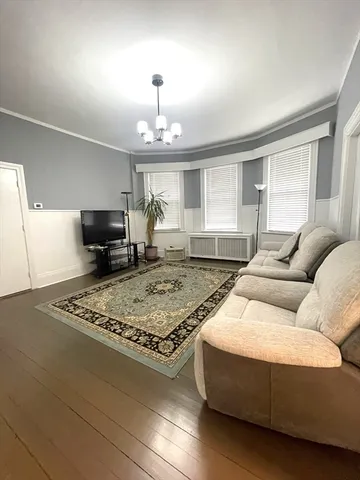 a living room with furniture rug and window