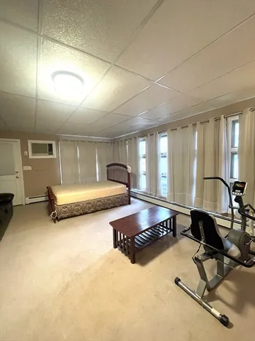 a bedroom with furniture and large window