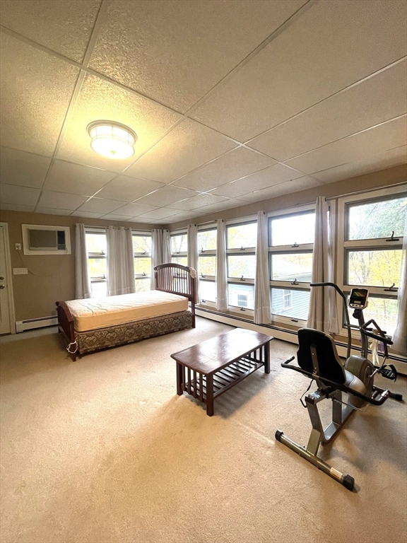 41 Hardwick Street, Unit 1 Boston, MA 02135 - Photo 6 of 11 a living room with furniture gym equipment and a large window
