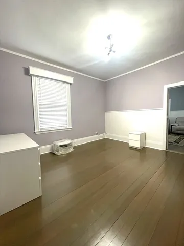 a view of a room with window and hardwood floor