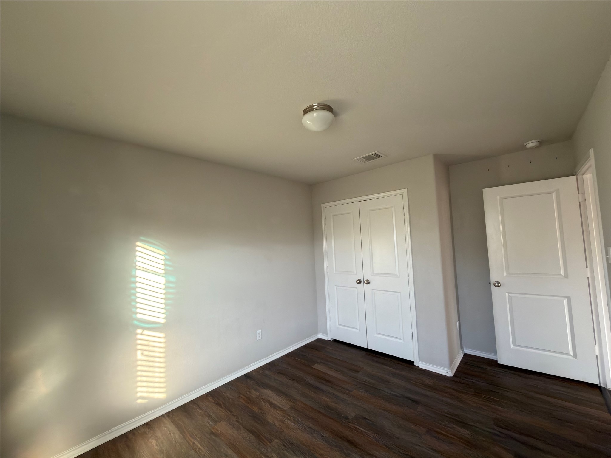 21700 Urraca Lane Pflugerville, TX 78660 - Photo 11 of 40 Unfurnished bedroom with dark wood-style floors and a closet