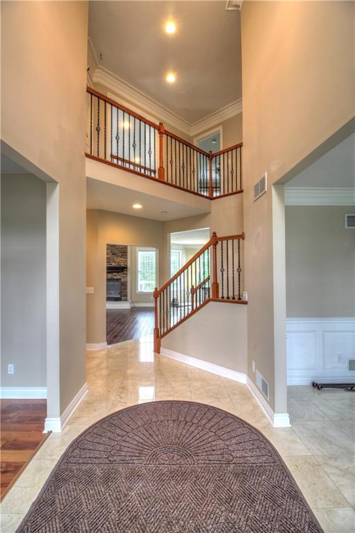 129 Chestnut Ridge Drive Beaver Falls, PA 15010 - Photo 2 of 25 Simply elegant Two-Story Foyer offers a great view of the upper open walkway adorned with custom crown moulding, wrought iron & woodwork, overhead ligthing.