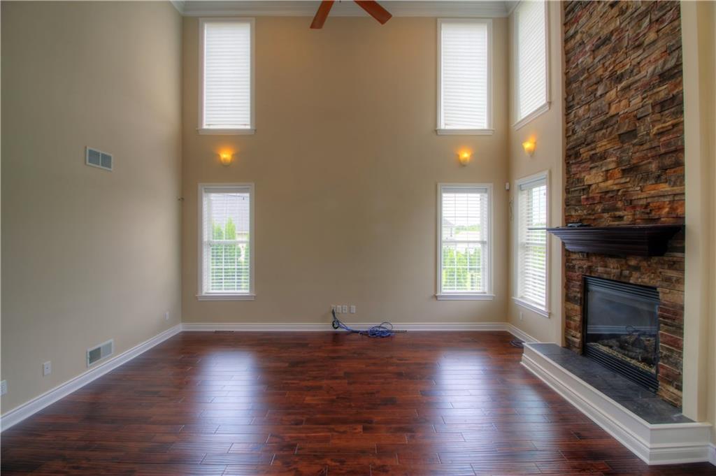 129 Chestnut Ridge Drive Beaver Falls, PA 15010 - Photo 13 of 25 The Great Room is sure to be a favored gathering place with its 20-foot ceiling boasting custom moulding, full wall windows for abundant natural light, rich hardwoods that allow the 20-foot stone fireplace to Pop!