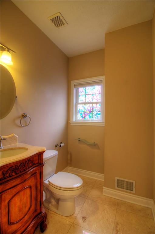 129 Chestnut Ridge Drive Beaver Falls, PA 15010 - Photo 17 of 25 First Floor powder room boasts style with its marble flooring, detailed vanity and angled ceiling!