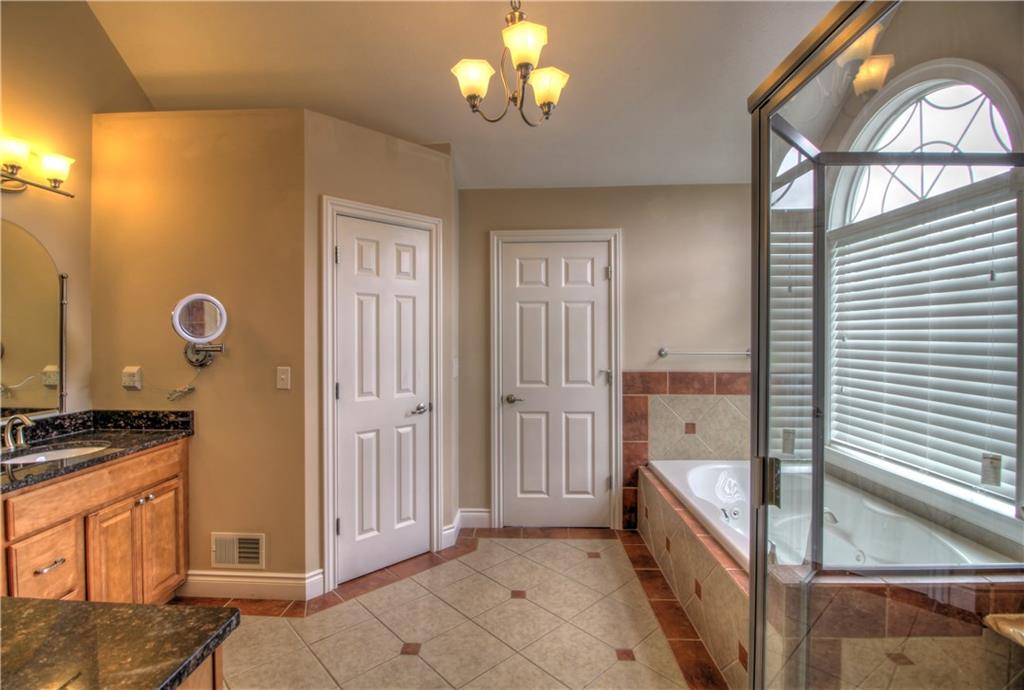 129 Chestnut Ridge Drive Beaver Falls, PA 15010 - Photo 18 of 25 The Master Bath features warm wood cabinetry for both he and she, walk in closet, water closet, a jet tub, paladium window and tiled shower!