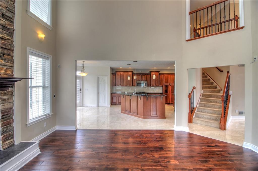 129 Chestnut Ridge Drive Beaver Falls, PA 15010 - Photo 21 of 25 This angle showcases the flow from the Great Room to Kitchen and elegant staircase leading to the open walkway above. Designed for entertaining from 2 to 40+ guests with ease!