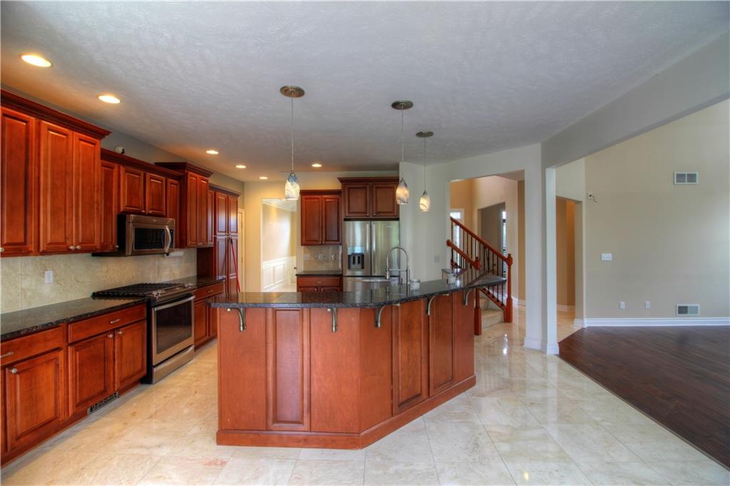 129 Chestnut Ridge Drive Beaver Falls, PA 15010 - Photo 5 of 25 Marble flooring, tiered lighting, eating counter on the kitchen island adds additionall seating for 5 or more! Ample custom cabinets, counters and backsplash you have to see in person to appreciate!