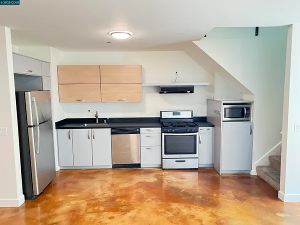 a view of a kitchen with a sink and a refrigerator