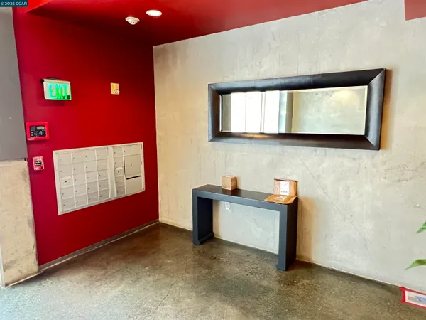 a view of a hallway with wooden floor and living room