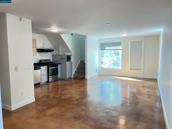 a kitchen with granite countertop a refrigerator and a stove