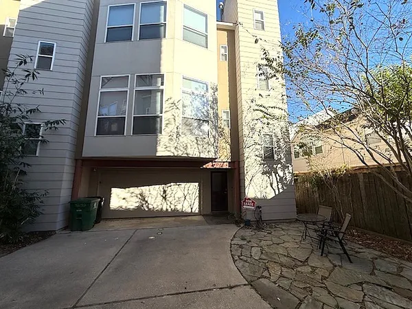 a front view of a building with a garden