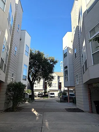 a view of a building and car parked on the street