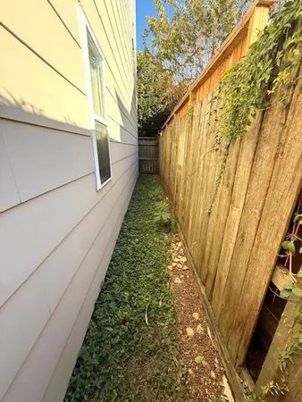 a view of a pathway both side of house