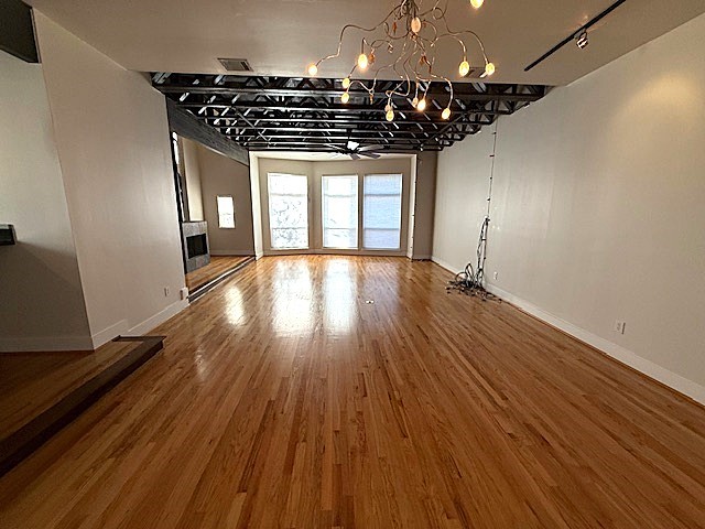 4243 Purdue Street, Unit C Houston, TX 77005 - Photo 7 of 48 a very nice looking room with wooden floor and a ceiling fan