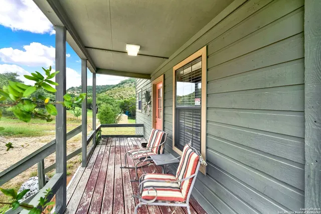 a view of balcony with wooden floor and outdoor seating
