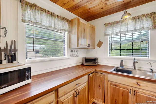 a kitchen with a sink a counter top space and a window