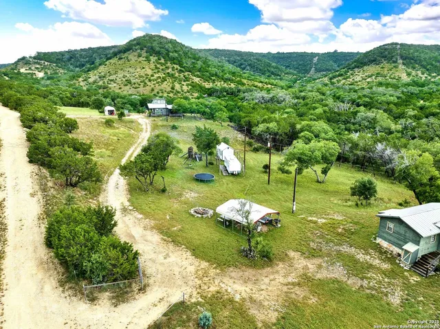 a backyard of a house with a yard and outdoor seating