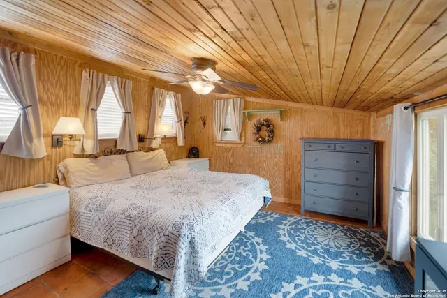 a spacious bedroom with a bed and a window