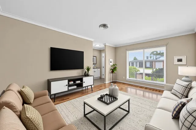 a view of a dining room with furniture and a potted plant