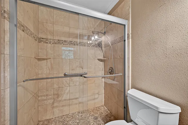 a view of a backyard with wooden fence and porch