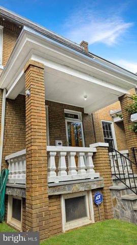 a view of a house with a barbeque and furniture