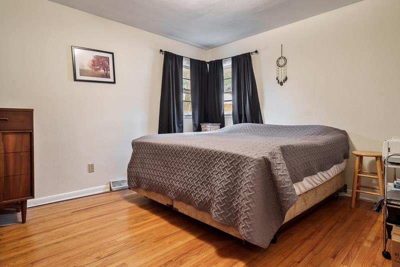3715 Rural Street Rockford, IL 61107 - Photo 21 of 35 a bedroom with a bed and wooden floor