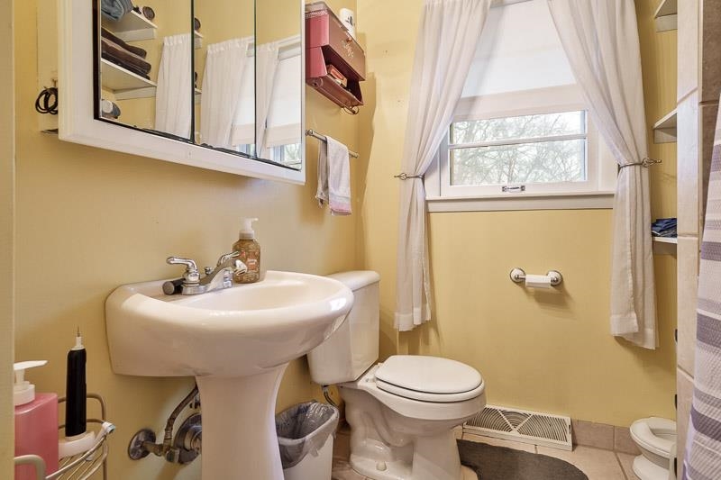 3715 Rural Street Rockford, IL 61107 - Photo 3 of 35 a bathroom with a sink and mirror with toilet